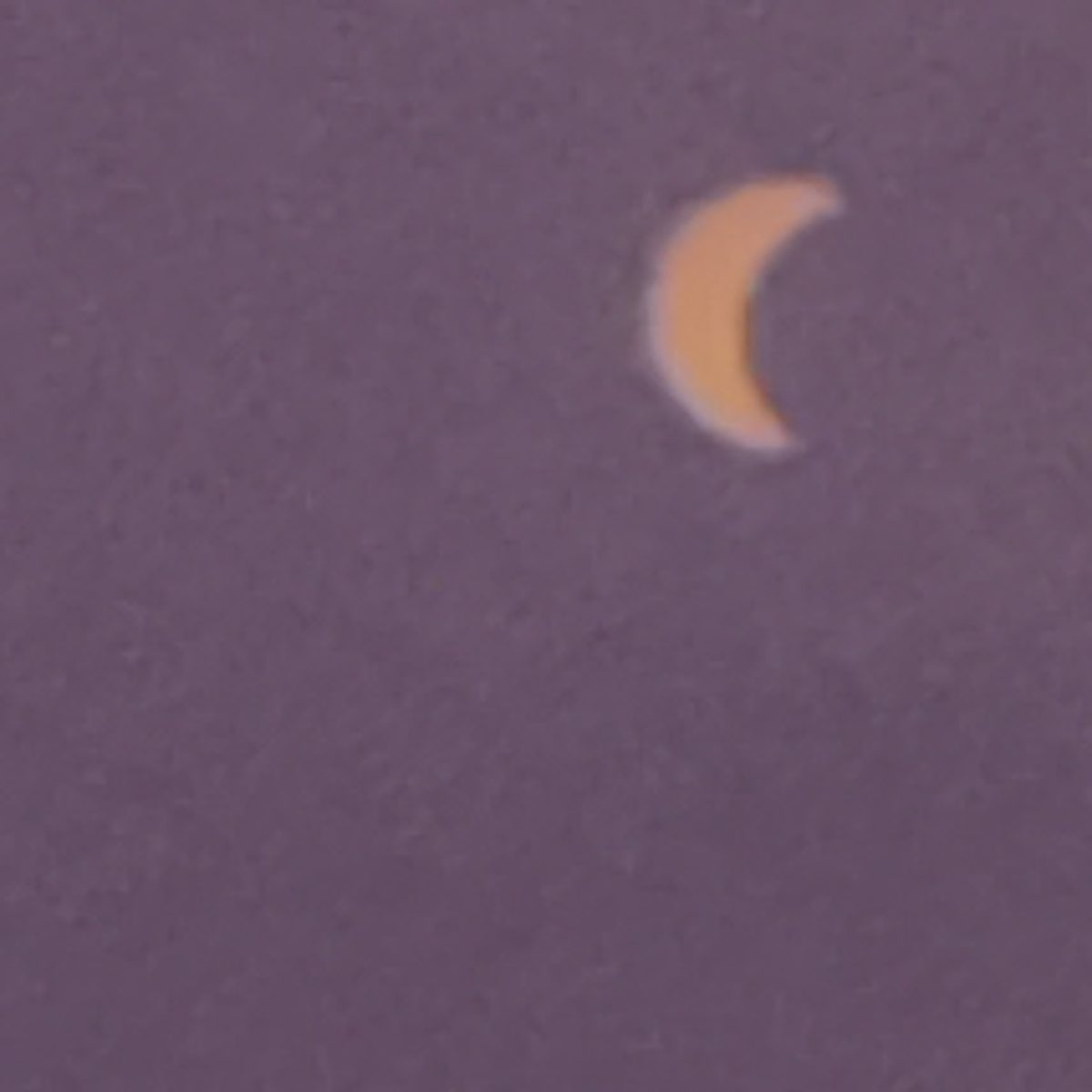 Partial eclipse crescent photographed as the light softened over A Coruña