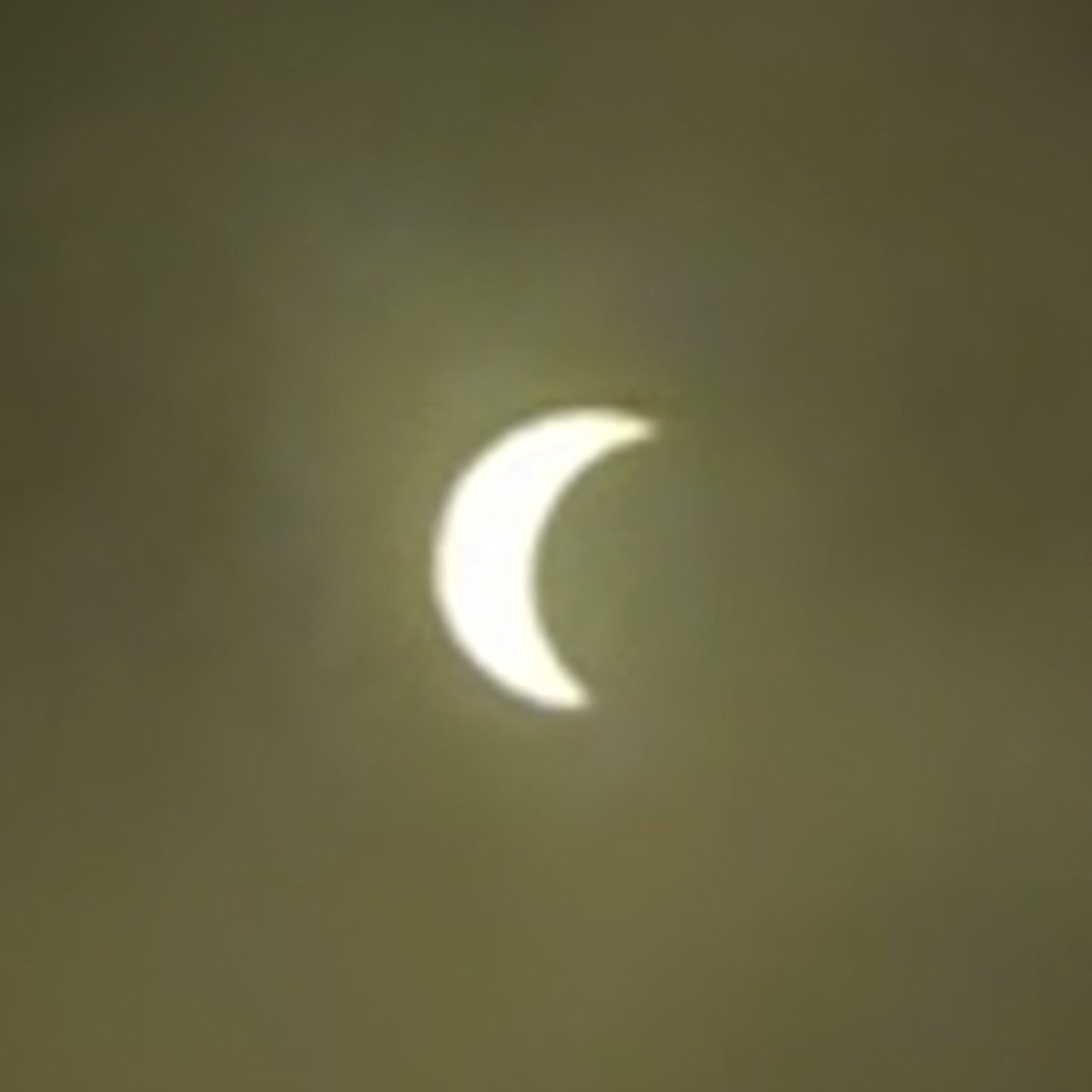 Bright crescent of the Sun seen through clouds during Wake Up Eclipse A Coruña